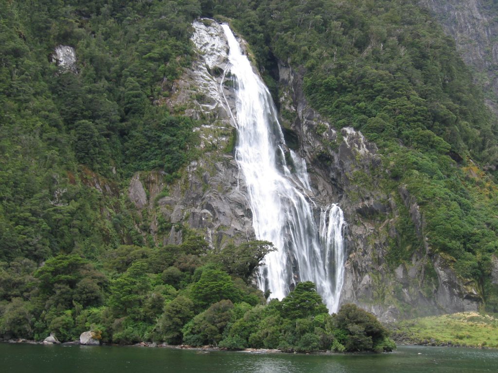 Real Journeys' ship sails past Bowen Falls, Milford Sound. 